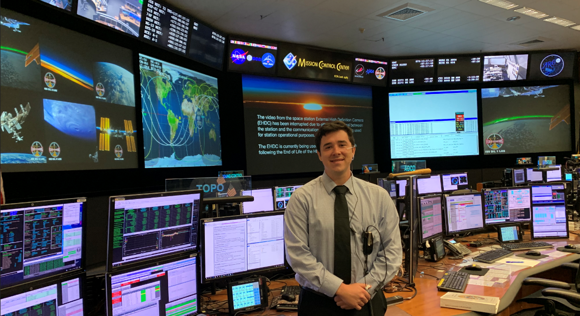 ARCS Scholar Samuel Buckner stands in the ISS mission control room