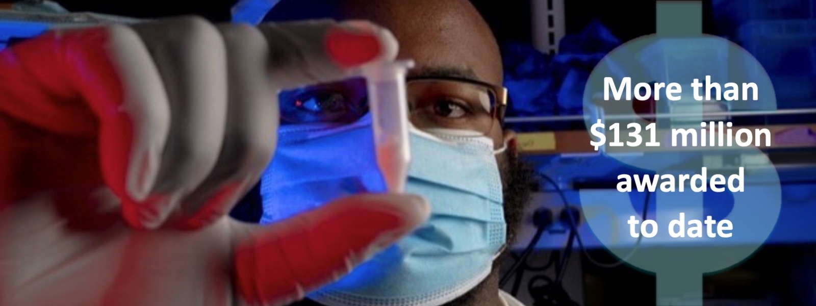 Jervaughn Hunter holding test tube with dollar sign indicating more than $131 million awarded to date